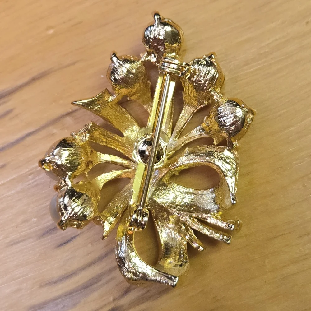 Vintage gold tone brooch with faux pearl accents